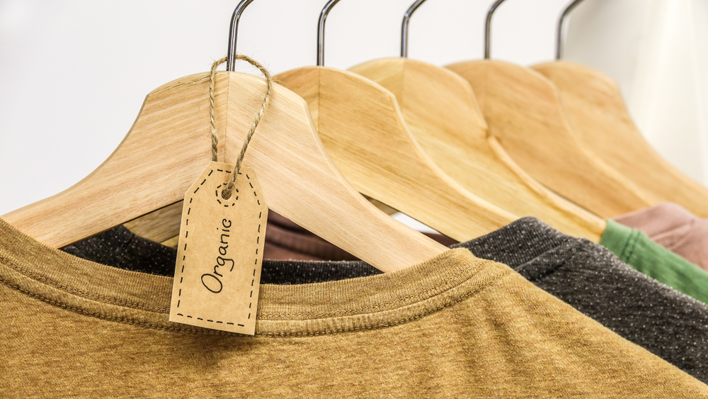 Organic,Clothes.,Natural,Colored,T Shirts,Hanging,On,Wooden,Hangers,In